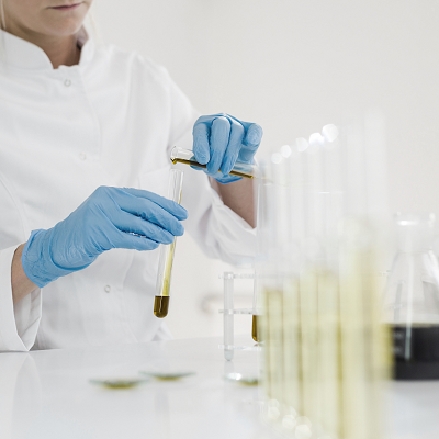 Bio Scientist putting chemicals in a flask. Codex Beauty - Bio science behind beauty